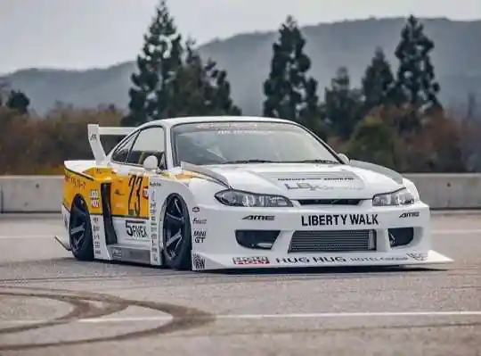 Nissan Silvia S15 with Liberty Walk bodykit, featuring the text 'HUG HUG' on its bumper
