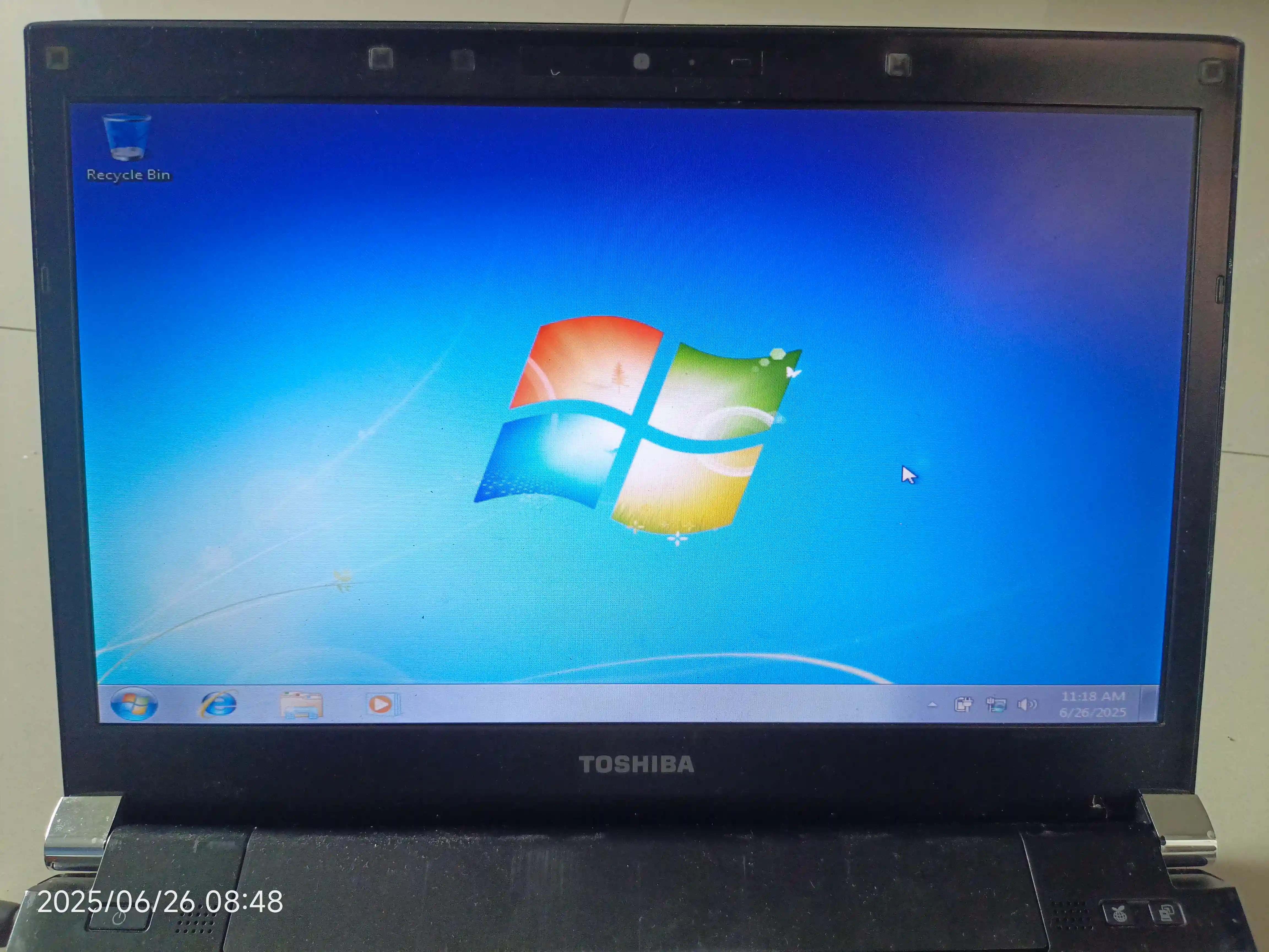 The Toshiba PORTEGE R700 Showing its screen and Windows 7's default Aero wallpaper